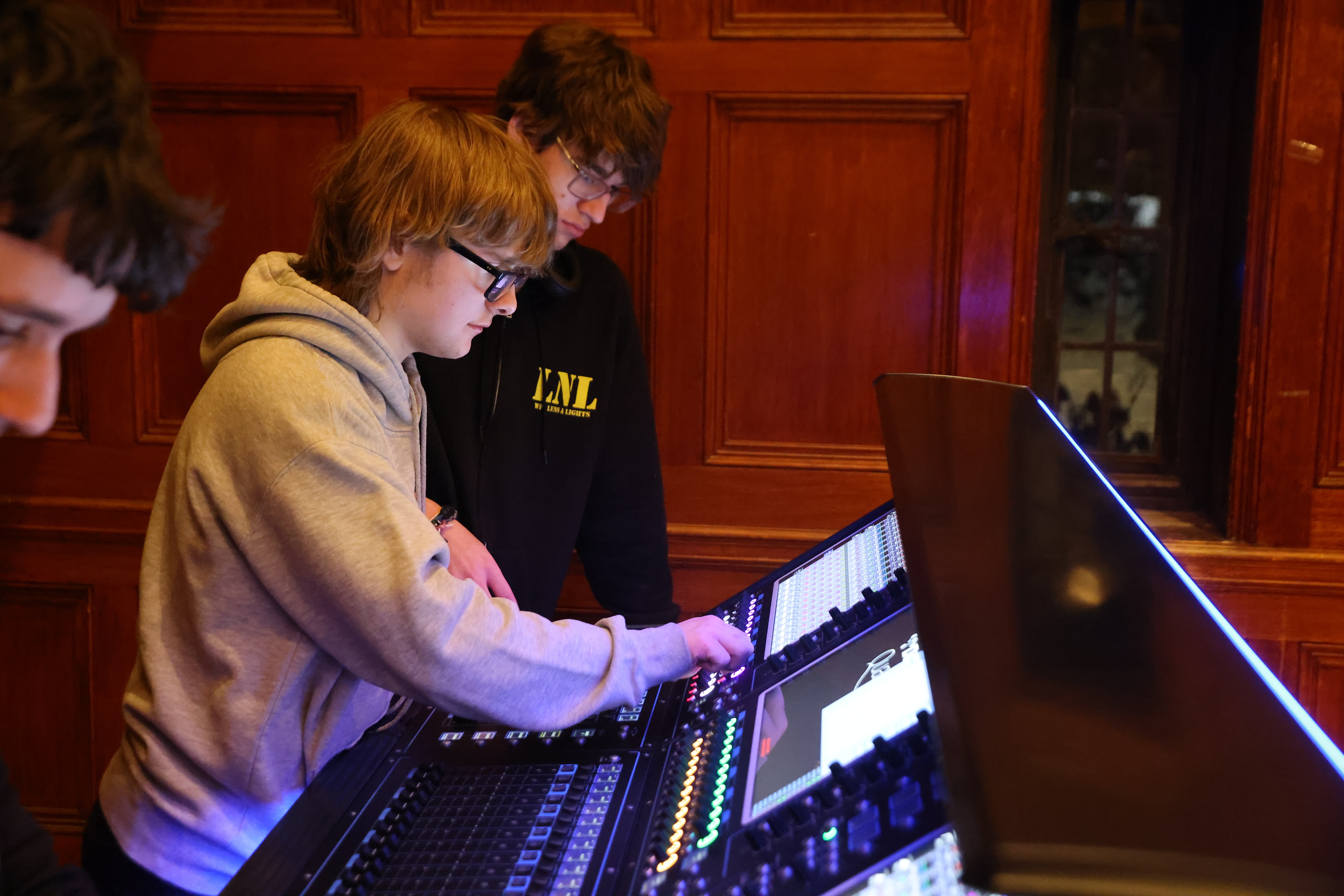 LNL member teaching another member on a sound console