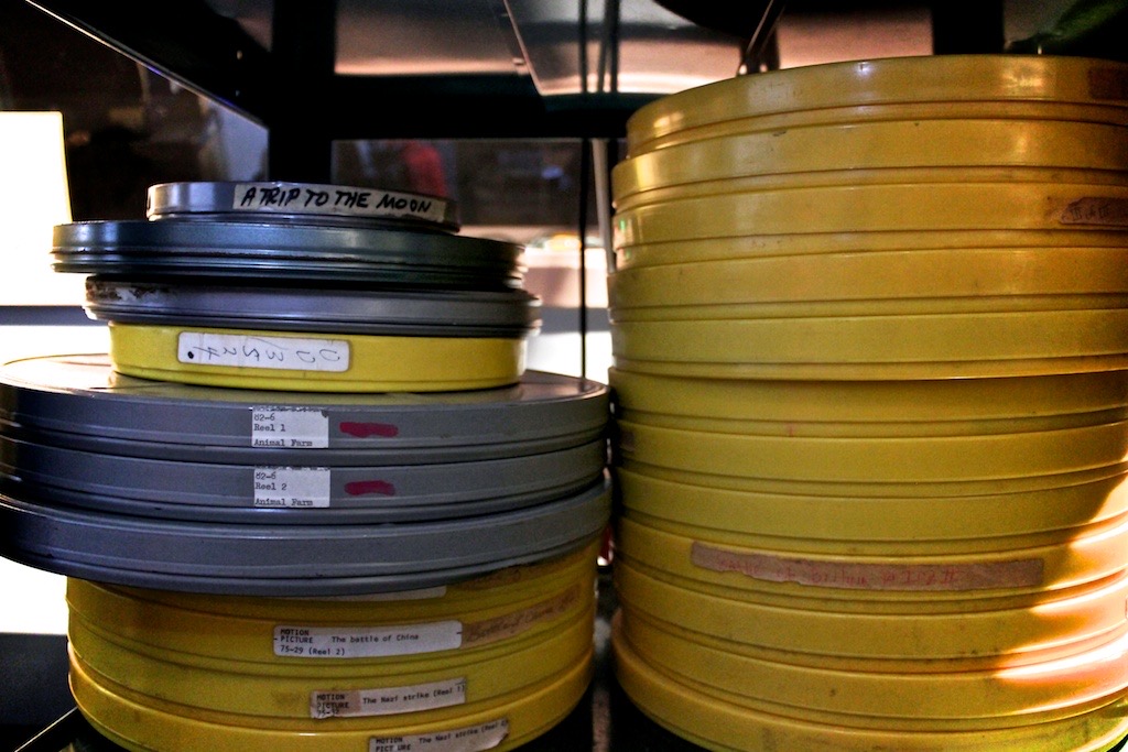 Reels of 16mm film stored on shelves